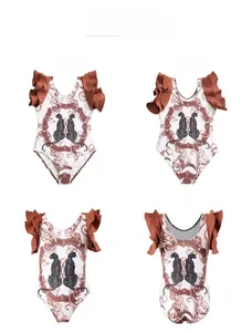 Detail of girls one-piece swimsuit with leopard print and ruffled shoulder design