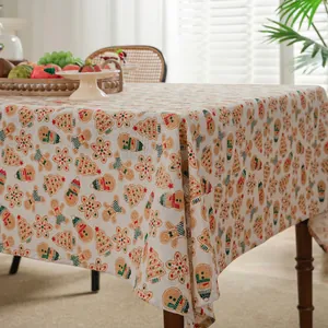 Christmas gingerbread man and snowman print linen tablecloth in a cozy dining setting