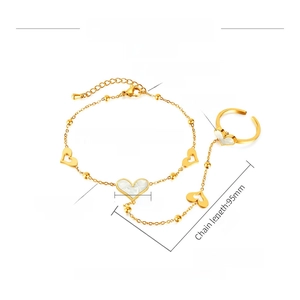 Detail view of gold heart ring bracelet with white mother of pearl and steel measurements