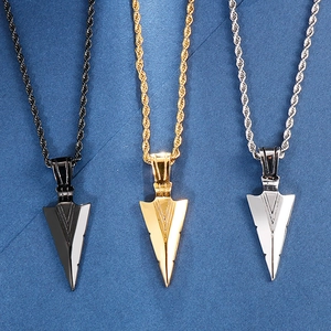 Trio of stainless steel arrow pendant necklaces in black, gold, and silver finishes