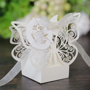Detail of white laser-cut butterfly gift box with beige ribbon and Thank You tag