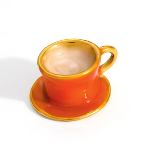 Miniature orange ceramic coffee cup with gold rim and beige latte liquid detail