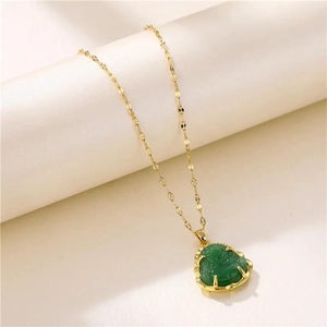 Titanium steel gold necklace featuring a green Laughing Buddha pendant on a light display