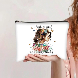 Detail of canvas pouch featuring a girl reading books illustration and zipper closure