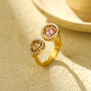Detailed close-up of adjustable gold ring featuring pink crystal, pear gem and pearls