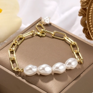 Detail of baroque pearl bracelet with gold paperclip chain and lobster clasp
