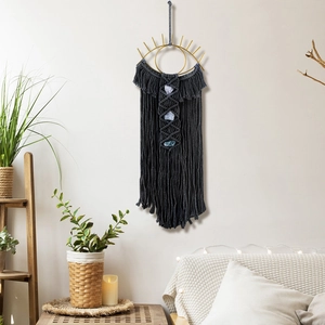 Detail of evil eye wall hanging featuring handmade cotton rope and natural crystal stones