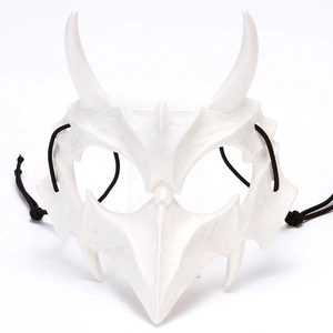Macro detail of white bone-style dragon mask with textures and black elastic strap