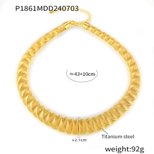 Detail of gold titanium steel spring necklace with lobster clasp and extension chain