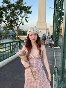 Detail of pink plaid crop top and ruffle skirt set with a white knit beanie hat