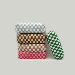 Detailed knit checkerboard pouches in multiple colors with soft woven texture