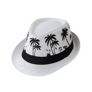 White straw fedora hat with black palm tree prints and a stylish decorative band