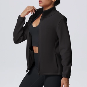 Detail of high-neck black sports jacket showing zipper closure and fabric texture