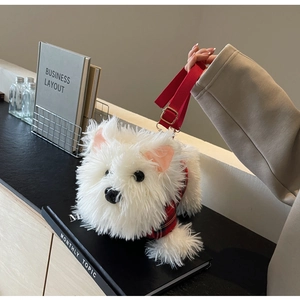 Detail of white plush Westie dog bag wearing a red plaid vest with adjustable strap