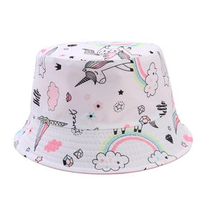 Detailed close-up of children's white sun hat featuring rainbow unicorn and star prints