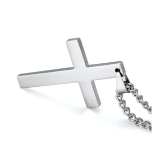 Macro shot of minimalist silver polished cross pendant with matching metal chain necklace