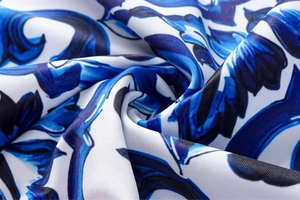 Macro detail of Mediterranean blue and white floral print swimsuit fabric texture