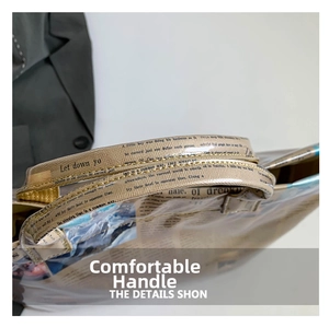 Detail of reinforced handles with yellow stitching on a vintage newspaper print tote bag