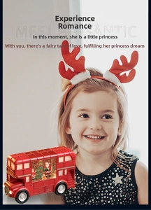 Close-up of a festive red Christmas bus ornament with Santa and snow inside