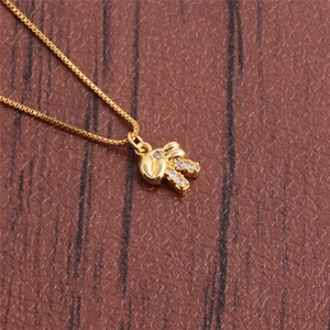 Close-up of a gold-plated rabbit pendant with zircon stones on a fine box chain necklace