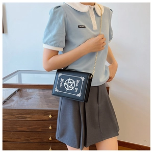 Gothic book-shaped crossbody bag with white pentagram print and golden metal chain strap