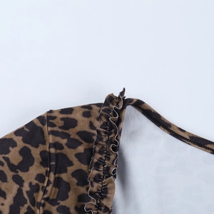 Macro detail of leopard print top featuring ruffle trim neckline and neat stitching