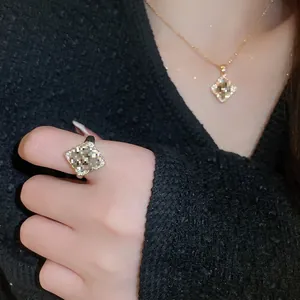 Vintage floral jewelry set with gold plating and rhinestones featuring ring and necklace