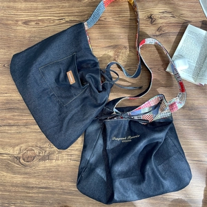 Detail showing oversized denim tote bags with vintage floral lining and leather logo tag