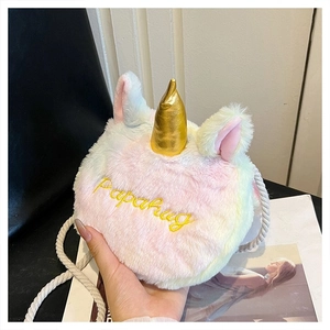 Detailed close-up of rainbow plush unicorn crossbody bag with soft faux fur and gold horn