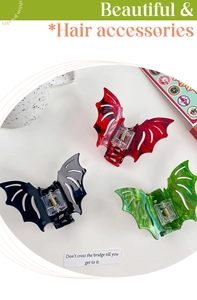 Three gothic bat wing hair claws in red marble, black, and glitter green acetate finishes