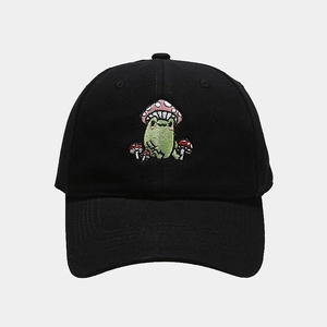 Close-up of cute cartoon frog with mushroom embroidery on black cotton baseball cap