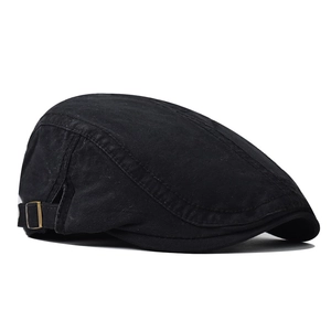 Detail of black cotton beret cap featuring adjustable metal buckle and stitching