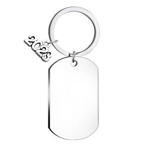Detail of polished silver stainless steel dog tag keychain with a 2023 pendant for DIY