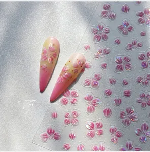 Macro shot of 3D embossed flower nail stickers with laser glitter and cherry petals