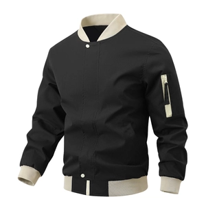 Detail of black bomber jacket with contrast cream ribbing and zipper arm pocket