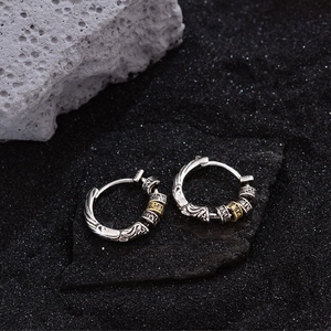 Vintage gold and silver contrast hoop earrings with engraved floral arabesque patterns