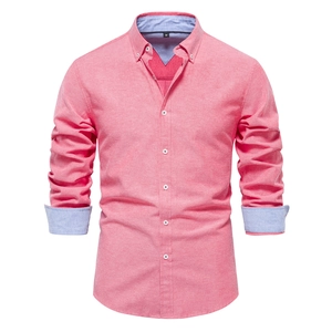 Detail of pink long sleeve shirt showing light blue contrast collar and inner cuff lining