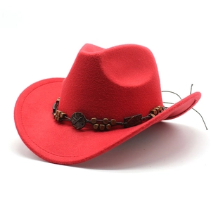 Detail of red wool felt cowboy hat with beaded band and embossed vintage ornament