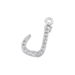 Macro shot of silver letter J pendant with cubic zirconia inlay on white background