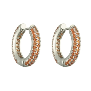 Close-up of luxury silver hoop earrings with three rows of pavé-set orange crystals