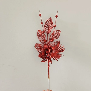 Close-up of red glitter Christmas floral pick with hollowed leaves and decorative berries