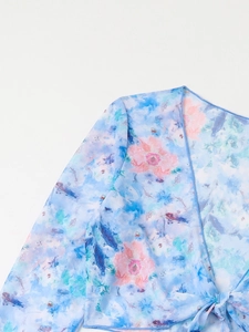 Detail of light blue floral mesh cover-up with bell sleeves and tie-front closure