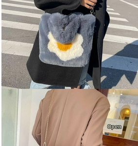 Detail of gray plush tote bag with yellow flower pattern and metal chain strap