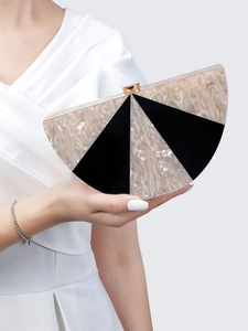 Detailed shot of marbled beige and black acrylic semi-circle clutch with gold hardware