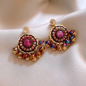 Detail of vintage bohemian tassel earrings with pink stones and multicolored beads