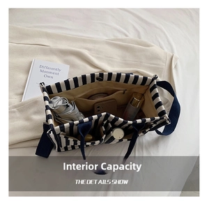 Detail showing internal capacity and pockets of the striped canvas tote bag