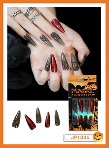 Detailed view of Halloween long stiletto press on nails with spider webs and red glitter
