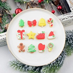 Christmas mini cookie cutter set with 12 holiday shapes displayed on a gold rimmed plate