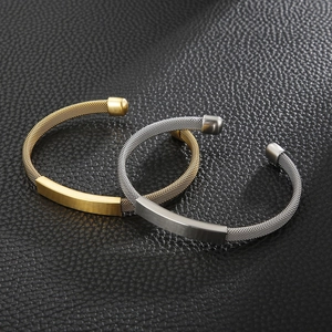 Close-up of mesh weave stainless steel C-shape bracelets in gold and silver finishes