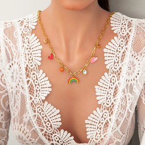 Detail of a gold stainless steel necklace with colorful rainbow and heart pendants